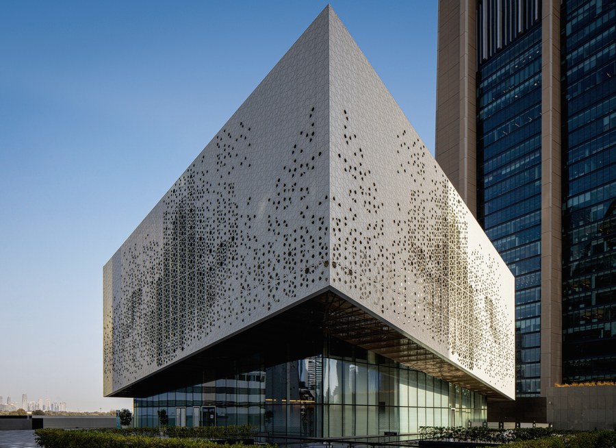 Institutional stone facade with tall vertical fins